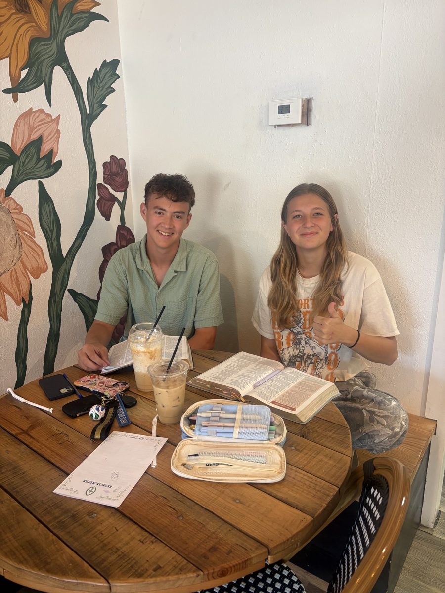 Two people with Bibles open at a table