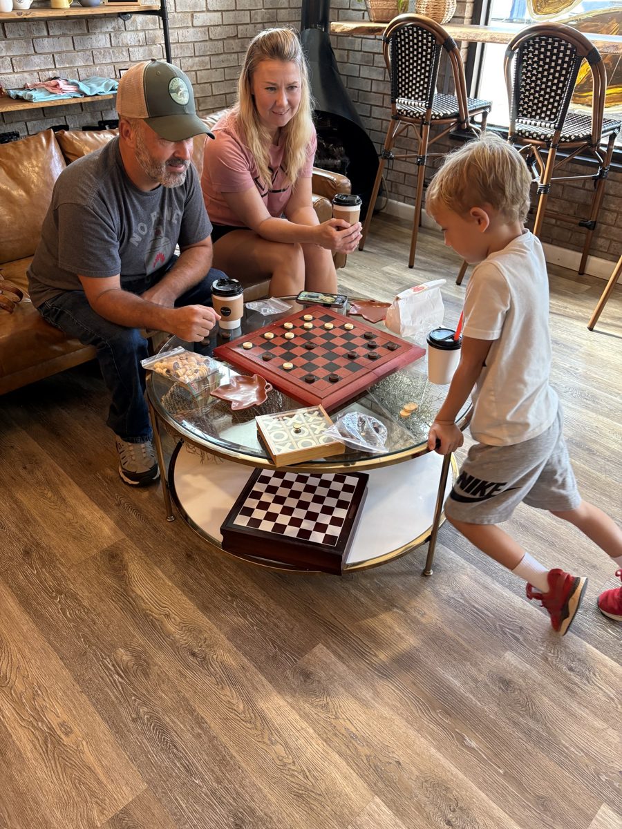 A grandfather and a boy playing checkers